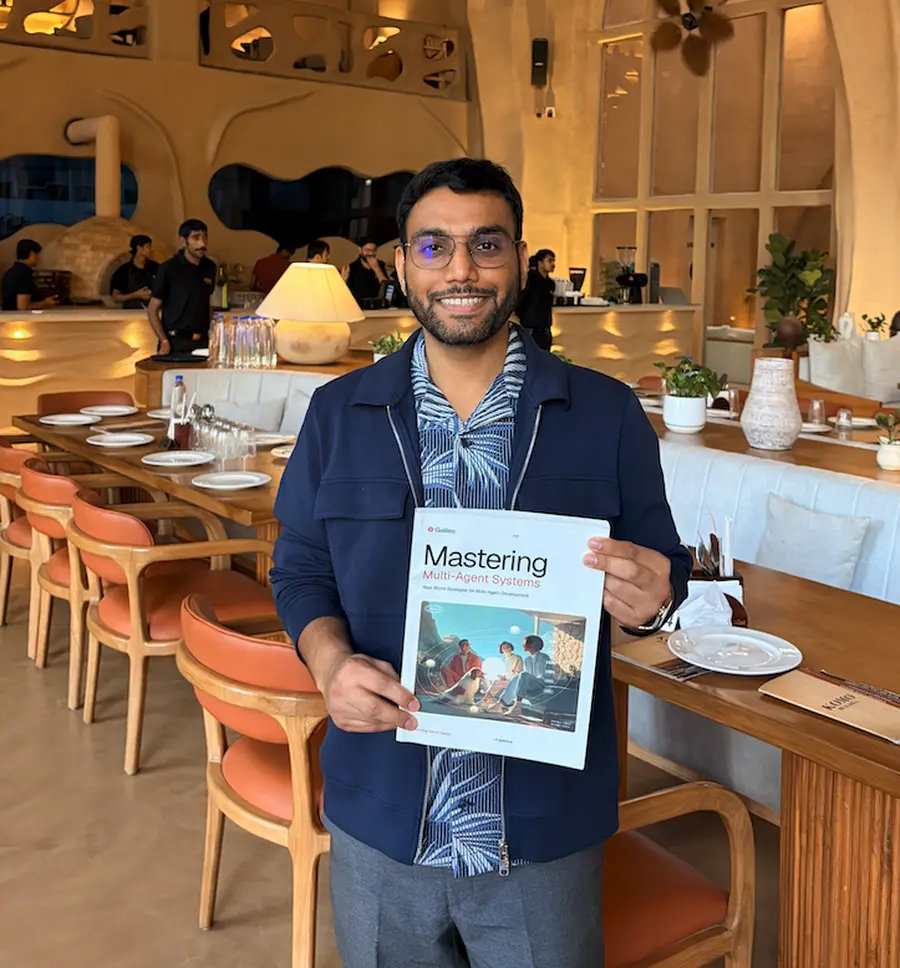 Pratik holding the Eval Engineering book